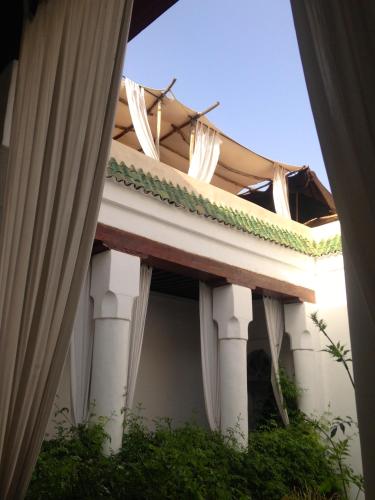 a view of the outside of a building with columns at Riad Tizwa Marrakech in Marrakech