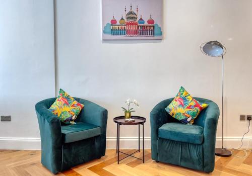 two green chairs and a table in a room at A Stones Throw By My Getaways in Brighton & Hove