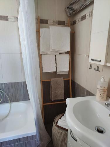 a bathroom with a sink and a toilet and a tub at Studio Anlia in Nea Makri