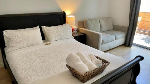 a bedroom with a bed with a basket of towels at Hollywood’s Suite in Los Angeles