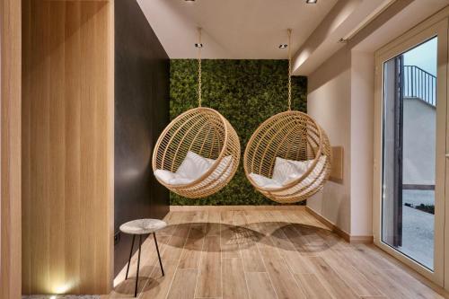two wicker chairs hanging from a wall at RELAIS COLLE BUONO in Alvito