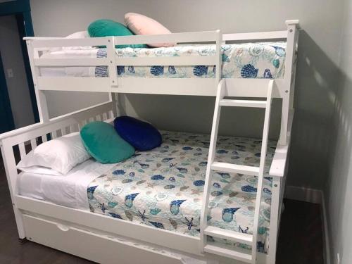 a white bunk bed with pillows and a ladder at CAPE COD'S BEST BEACH GETAWAY in Falmouth