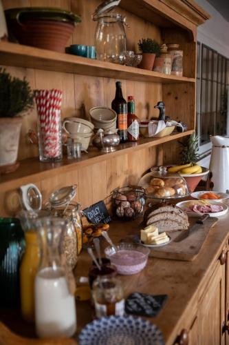 a kitchen counter with lots of food on it at The Cotley Inn in Wambrook