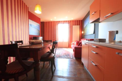 a kitchen with a table and a living room at Felicin - Palazzo Boeri Panoramic Suites in Monforte dʼAlba