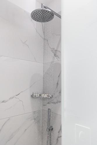 a shower in a bathroom with a glass door at Angel Saranda Palace in Sarandë