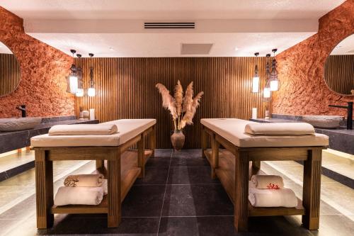 a massage room with two tables and a vase at Genesis Hotel&Spa Alaçatı in Alaçatı