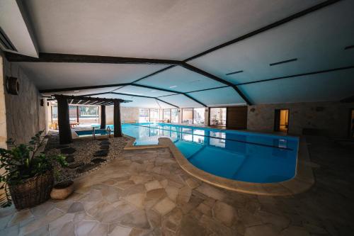 a large swimming pool with a large swimming poolvisor at BIO HOTEL & WELLNESS Zlatý Hýľ in Hýľov