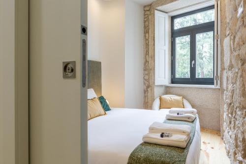 a bedroom with a bed and a window at ORM Carregal Apartment in Porto