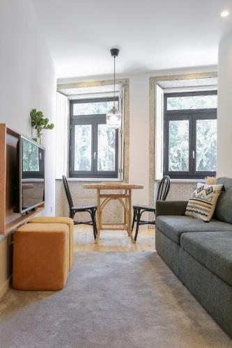 a living room with a couch and a table at ORM Carregal Apartment in Porto