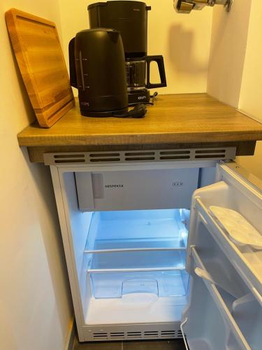 an open refrigerator with a coffee maker on top of it at Apartment Seesrauschen für 2-4 Personen mit Pool in Dahme