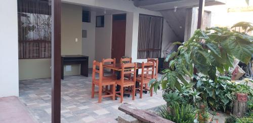 a wooden table and chairs on a patio at Tilcafé Bed & Breakfast in Mollepata