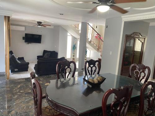 a living room with a dining room table and chairs at casa lomas de mazatlan in Mazatlán