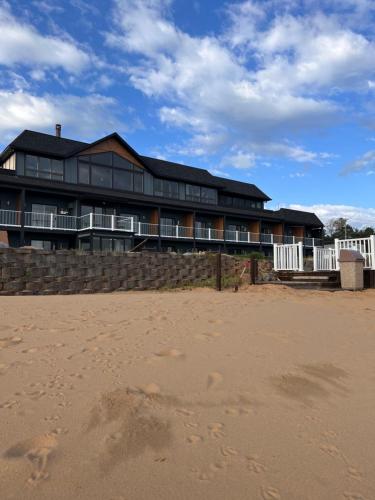 a large house on the beach with the sand at The Beach Haus - Traverse City in Traverse City