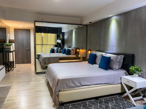 a bedroom with two beds with blue pillows at Lavenderbnb Room 8 at Mataram City in Yogyakarta