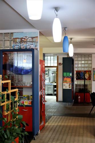 a room with a soda machine and a refrigerator at Hostel Soline in Portorož