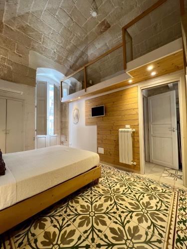 a bedroom with a large bed in a room at Vittorio Emanuele Apartment in Monopoli
