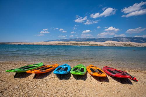 a group of five kayaks lined up on the beach at Terra Park SpiritoS in Kolan