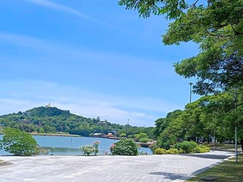 a view of a lake with a hill in the background at Fueangfu Home Hostel in Chaweng