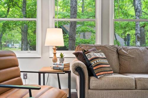 a living room with a couch and a table with a lamp at The Gingerbread House: 4 BR chalet, w/ Sunroom/Deck, sleeps 12, modern amenities in McGaheysville