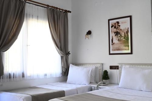 Posteľ alebo postele v izbe v ubytovaní Cunda Deniz Hotel