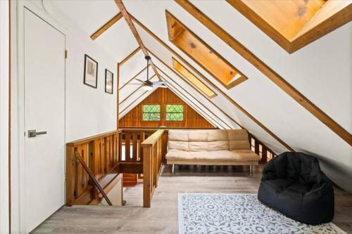 a room with a staircase with a chair and a door at The Gingerbread House: 4 BR chalet, w/ Sunroom/Deck, sleeps 12, modern amenities in McGaheysville