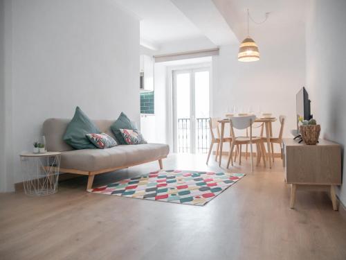 a living room with a couch and a table at Alcácer Central Apartments in Alcácer do Sal