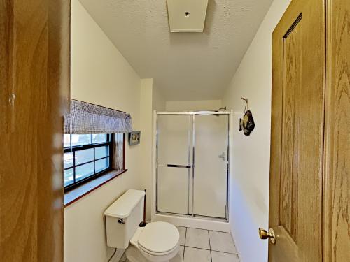 a bathroom with a toilet and a shower at Put in Bay Island Club 61 in Put-in-Bay