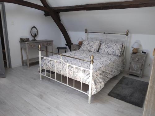 a bedroom with a white bed and a table at Reids Retreat in La Roche-lʼAbeille