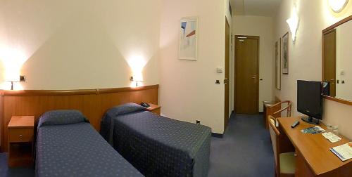 a hospital room with two beds and a desk at Valdenza Hotel in Campegine