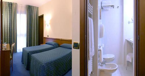 a hotel room with two beds and a sink at Valdenza Hotel in Campegine