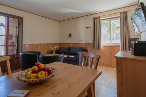 a kitchen and living room with a bowl of fruit on a table at Theater- und Feriendorf Königsleitn GmbH in Litschau