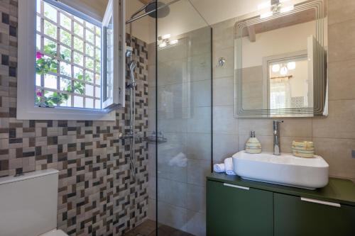 a bathroom with a sink and a shower at Messinian Monte e Mare in Kalamata