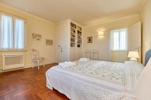 a bedroom with a large bed and a chair at Villa Ardea in Soiano del Lago