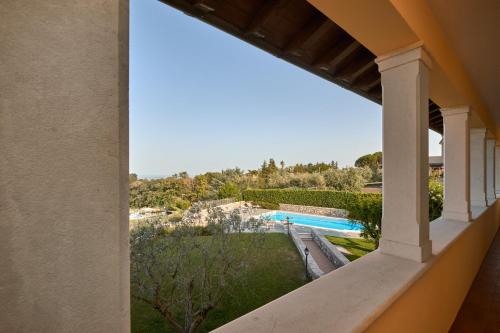 a view of the pool from the balcony of a house at Villa Ardea in Soiano del Lago