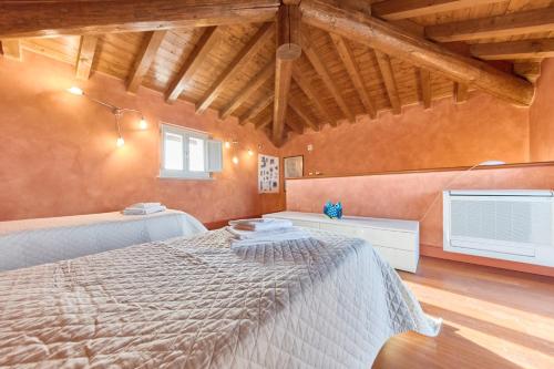 a bedroom with a bed in a room with wooden ceilings at Villa Ardea in Soiano del Lago