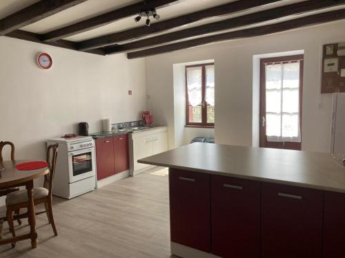 a kitchen with a large island in the middle at La Maison des Roses 1-Bed House in Genouille in Génouillé