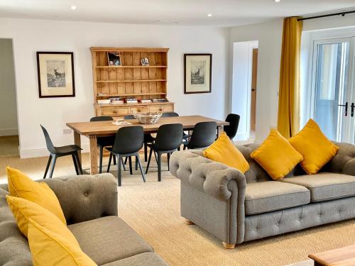a living room with a couch and a table at Rye Court Cottage - Stunning cottage in central Helmsley with parking in Helmsley