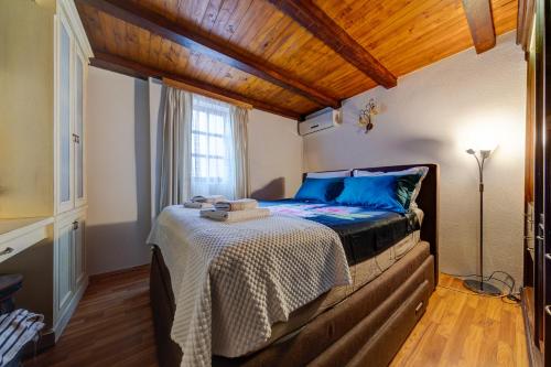 a bedroom with a bed with a wooden ceiling at Vincenza Apartment in Kotor