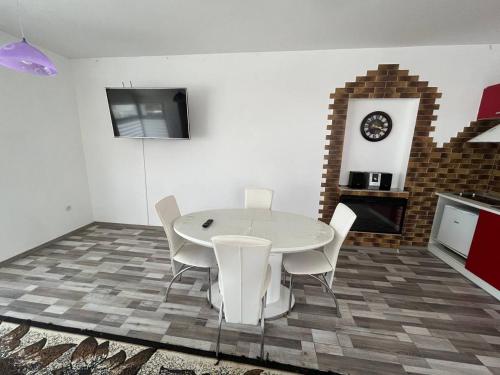 a dining room with a white table and white chairs at Апартаменти в центрі Трускавця in Truskavets