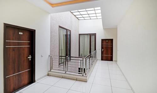 a hallway with two doors and a staircase at Treebo Magnum Chandigarh in Mohali