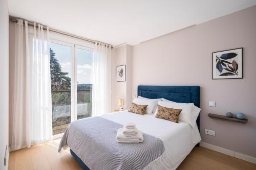 a bedroom with a bed with a large window at For You Rentals ROYAL PALACE CSV40 in Madrid