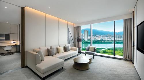 a living room with a couch and a large window at Crowne Plaza Quanzhou Riverview by IHG in Quanzhou