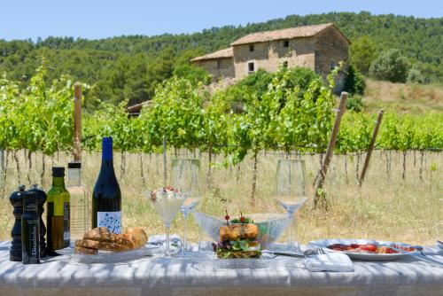 a table with wine bottles and wine glasses on it at Torre del Marqués Hotel Spa & Winery - Small Luxury Hotels in Monroyo