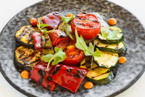 a plate of food with tomatoes and other vegetables at Torre del Marqués Hotel Spa & Winery - Small Luxury Hotels in Monroyo