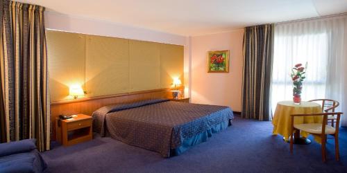 a hotel room with a bed and a couch at Valdenza Hotel in Campegine