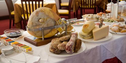 a table topped with plates of food on a table at Valdenza Hotel in Campegine
