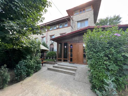 a house with a wooden door and some bushes at Claudia in Eforie Sud