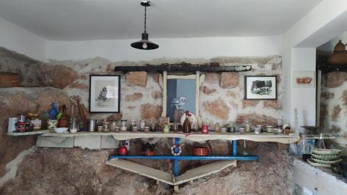 a kitchen with a stone wall with a sink at Dembelija Rooms in Virpazar