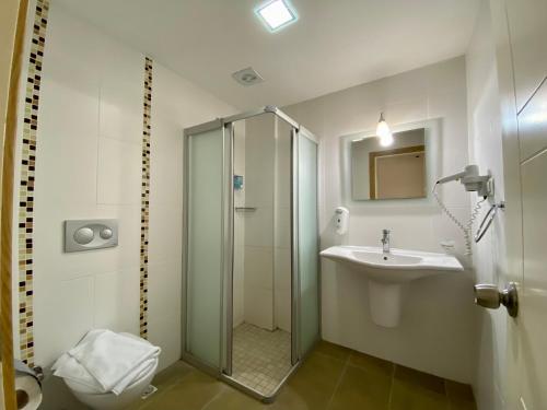 a bathroom with a shower and a sink at Konfor Suite Otel in Oludeniz