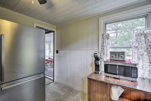 a kitchen with a microwave and a refrigerator at Point Pleasant Abode with Lagoon and Boat Dock! in Point Pleasant